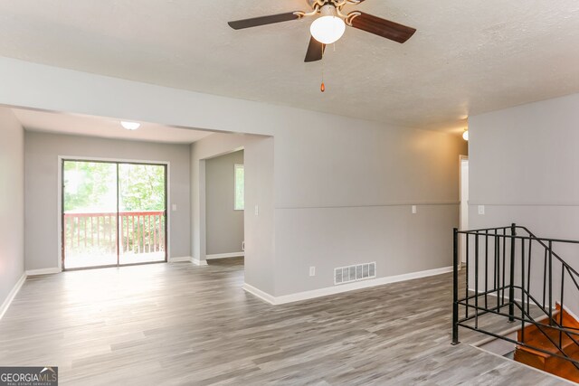4133 Conley Cir, Conley, GA 30288 - unfurnished room with wood finished floors, ceiling fan, and a textured ceiling