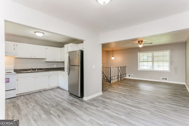 4133 Conley Cir, Conley, GA 30288 - kitchen featuring freestanding refrigerator, electric stove, dark countertops, and light wood-style floors