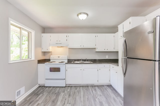 4133 Conley Cir, Conley, GA 30288 - kitchen with freestanding refrigerator, electric range, white cabinets, and light wood-style floors