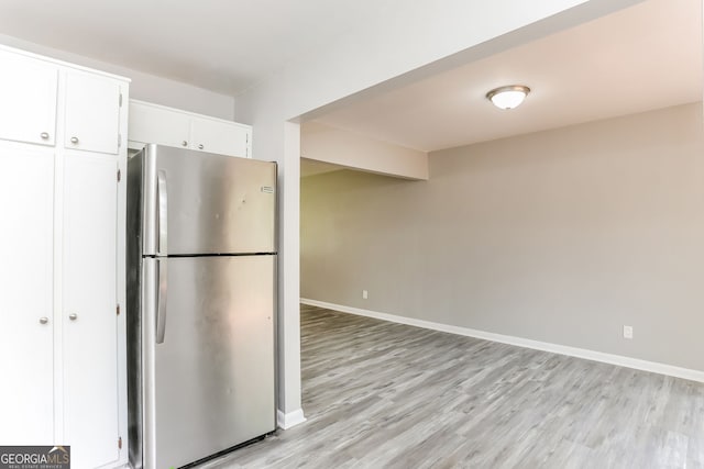 4133 Conley Cir, Conley, GA 30288 - kitchen with freestanding refrigerator, light wood finished floors, and white cabinets