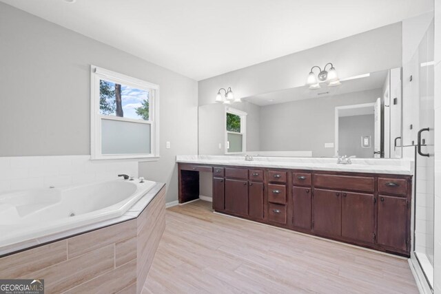 1501 Cayla Way, Statesboro, GA 30458 - full bath with double vanity, a tub with jets, a chandelier, wood finished floors, and tiled shower