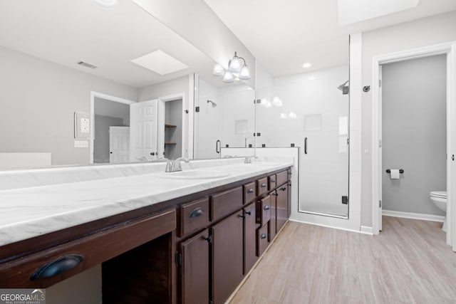 1501 Cayla Way, Statesboro, GA 30458 - full bath with double vanity, a stall shower, wood finished floors, and a skylight