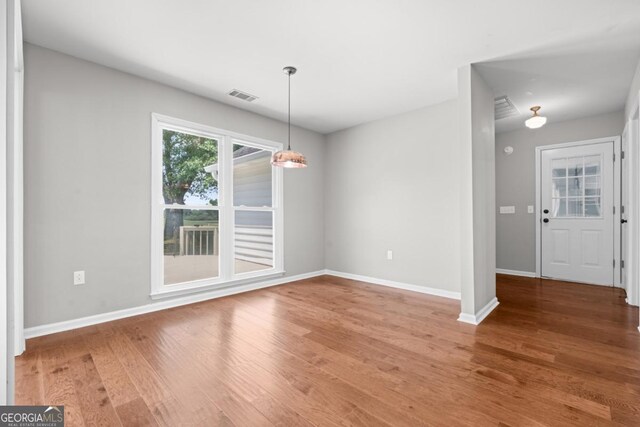 1501 Cayla Way, Statesboro, GA 30458 - unfurnished dining area with wood finished floors and baseboards