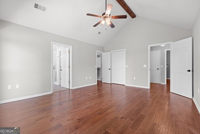1501 Cayla Way, Statesboro, GA 30458 - unfurnished bedroom featuring high vaulted ceiling, beam ceiling, wood finished floors, connected bathroom, and a ceiling fan