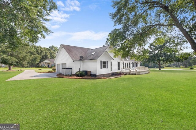 1501 Cayla Way, Statesboro, GA 30458 - view of side of home with concrete driveway, a yard, a deck, and a shingled roof