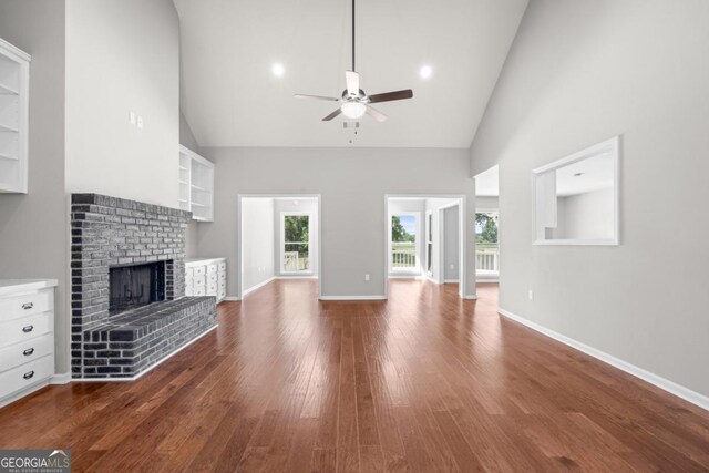 1501 Cayla Way, Statesboro, GA 30458 - unfurnished living room with a ceiling fan, a fireplace, high vaulted ceiling, plenty of natural light, and dark wood-type flooring