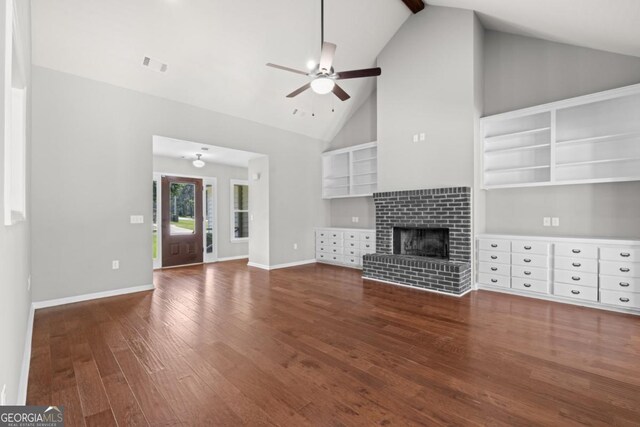 1501 Cayla Way, Statesboro, GA 30458 - unfurnished living room featuring wood finished floors, a ceiling fan, high vaulted ceiling, and a fireplace