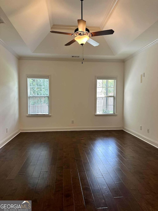 303 Norfolk Cir, Warner Robins, GA 31088 - empty room with a raised ceiling, healthy amount of natural light, ornamental molding, ceiling fan, and dark wood-type flooring