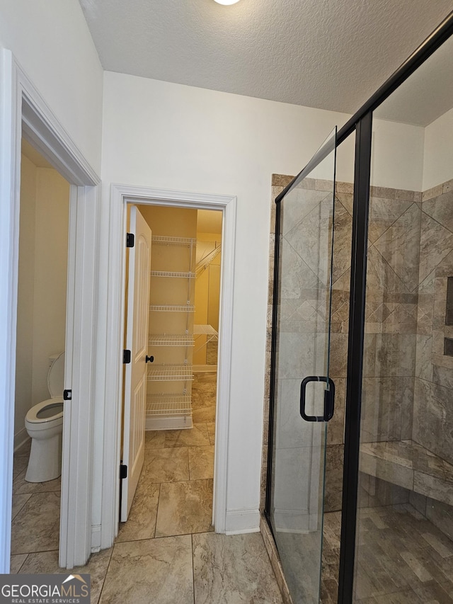 303 Norfolk Cir, Warner Robins, GA 31088 - bathroom featuring a spacious closet and a stall shower