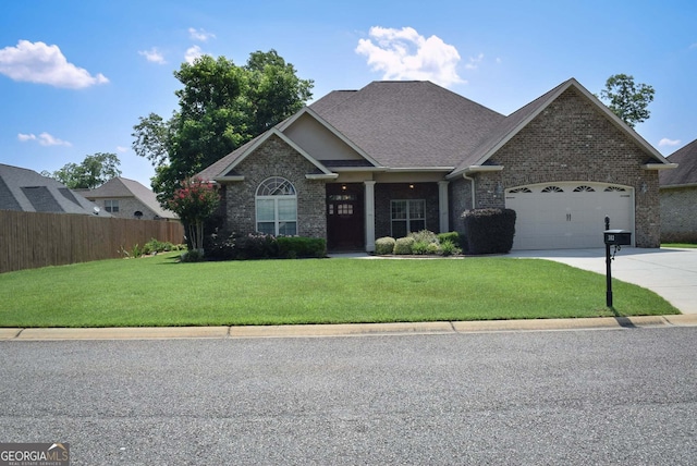 303 Norfolk Cir, Warner Robins, GA 31088 - craftsman house with driveway, brick siding, a garage, and a shingled roof