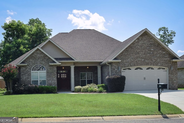 303 Norfolk Cir, Warner Robins, GA 31088 - craftsman-style house featuring driveway, brick siding, and a front lawn