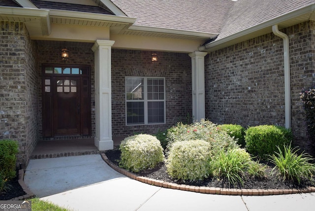 303 Norfolk Cir, Warner Robins, GA 31088 - entrance to property with roof with shingles, brick siding, and a porch