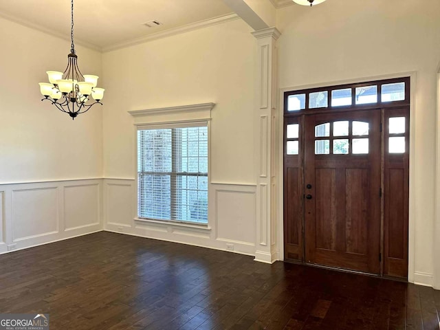303 Norfolk Cir, Warner Robins, GA 31088 - entryway with dark wood-style floors, a chandelier, a decorative wall, healthy amount of natural light, and a wainscoted wall