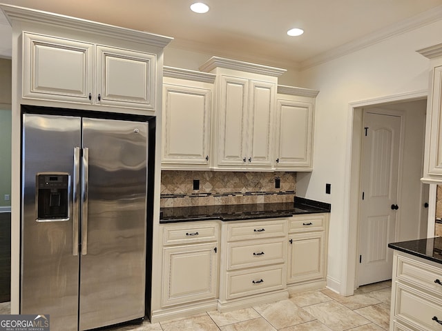 303 Norfolk Cir, Warner Robins, GA 31088 - kitchen featuring stainless steel refrigerator with ice dispenser, decorative backsplash, dark stone countertops, ornamental molding, and recessed lighting