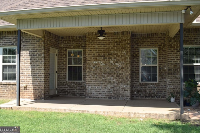 303 Norfolk Cir, Warner Robins, GA 31088 - doorway to property with a patio, ceiling fan, brick siding, and a shingled roof