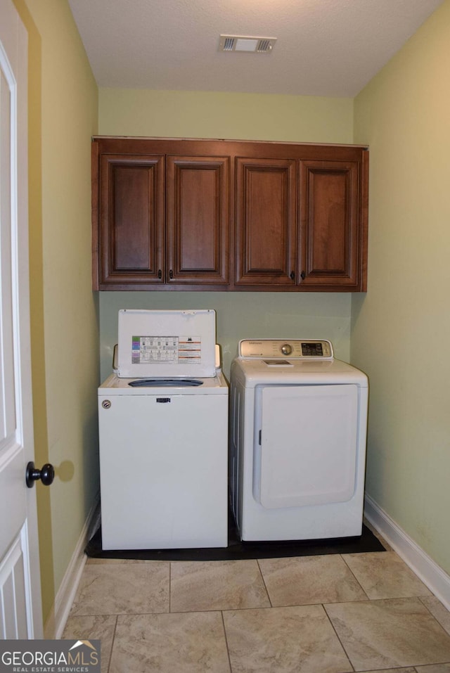 303 Norfolk Cir, Warner Robins, GA 31088 - laundry area with washer and dryer and cabinet space