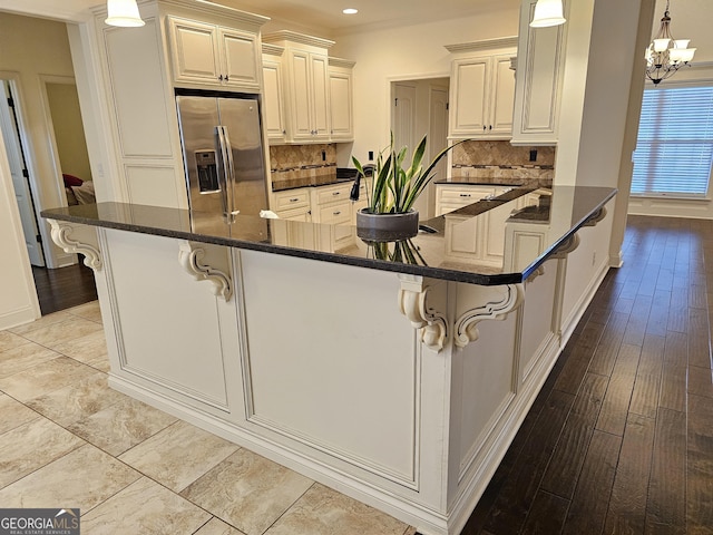 303 Norfolk Cir, Warner Robins, GA 31088 - kitchen featuring stainless steel refrigerator with ice dispenser, a chandelier, recessed lighting, decorative backsplash, and a peninsula