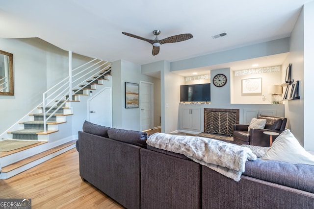 1192 Cleburne Ave NE, Atlanta, GA 30307 - living room featuring stairs, light wood finished floors, and a ceiling fan