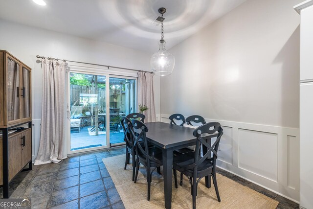 1192 Cleburne Ave NE, Atlanta, GA 30307 - dining room featuring stone tile flooring, wainscoting, and a decorative wall