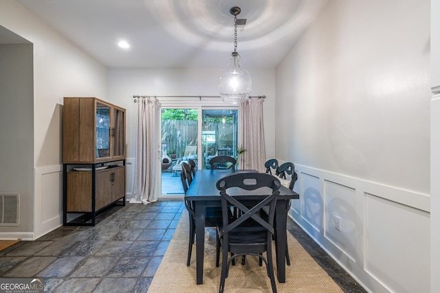 1192 Cleburne Ave NE, Atlanta, GA 30307 - dining space featuring wainscoting, a decorative wall, and dark stone finish flooring