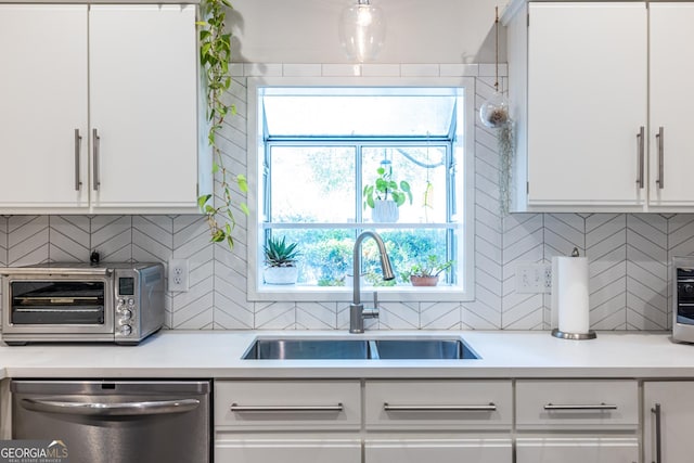 1192 Cleburne Ave NE, Atlanta, GA 30307 - kitchen with stainless steel dishwasher, white cabinets, and light countertops