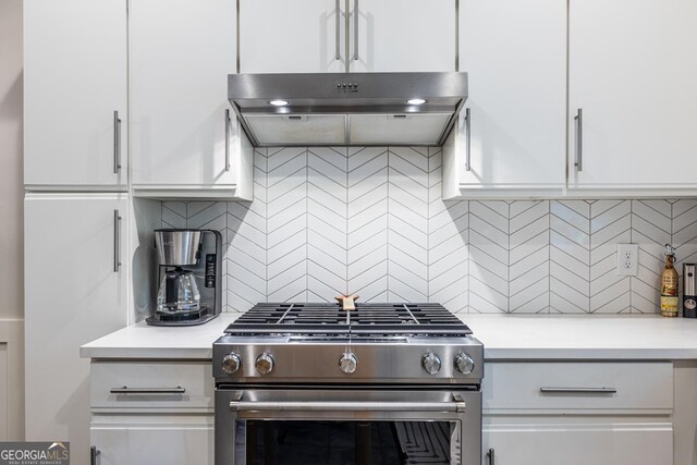 1192 Cleburne Ave NE, Atlanta, GA 30307 - kitchen with high end range, under cabinet range hood, light countertops, and white cabinetry