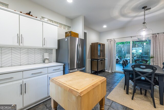 1192 Cleburne Ave NE, Atlanta, GA 30307 - kitchen featuring freestanding refrigerator, tasteful backsplash, white cabinetry, recessed lighting, and hanging light fixtures