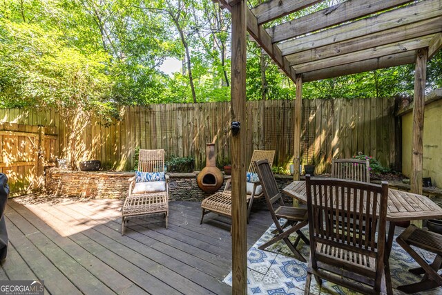 1192 Cleburne Ave NE, Atlanta, GA 30307 - deck with a fenced backyard, outdoor dining area, and a pergola