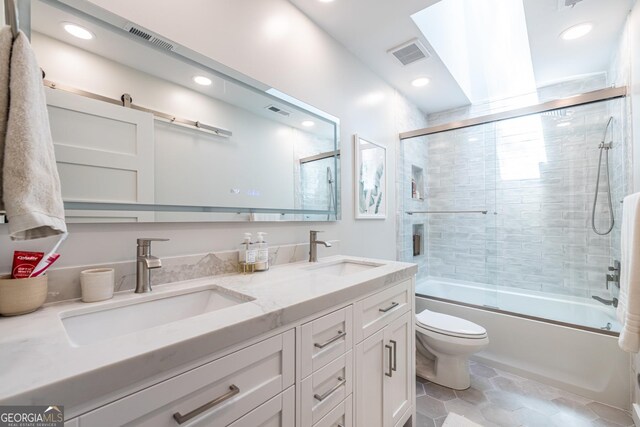 1192 Cleburne Ave NE, Atlanta, GA 30307 - bathroom with double vanity, enclosed tub / shower combo, tile patterned floors, and recessed lighting