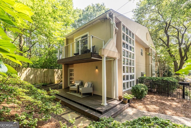 1192 Cleburne Ave NE, Atlanta, GA 30307 - rear view of property with stucco siding, a balcony, and a wooden deck