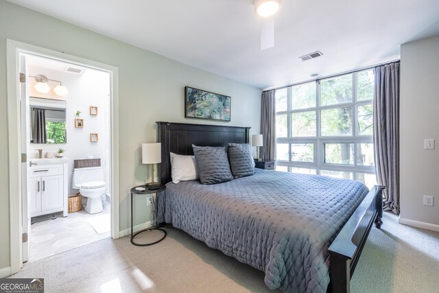 1192 Cleburne Ave NE, Atlanta, GA 30307 - bedroom with light colored carpet, multiple windows, and ensuite bath