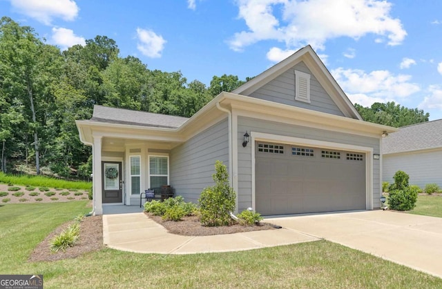 1290 Starboard Way, Greensboro, GA 30642 - view of front of house with concrete driveway, a front lawn, and a garage