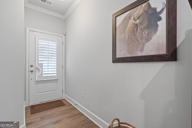 1290 Starboard Way, Greensboro, GA 30642 - doorway to outside with wood finished floors and crown molding