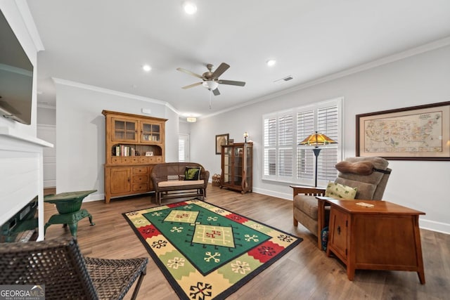 1290 Starboard Way, Greensboro, GA 30642 - sitting room with ceiling fan, recessed lighting, crown molding, wood finished floors, and a fireplace