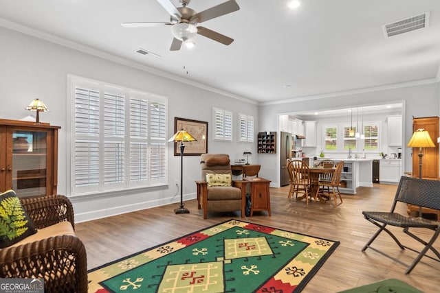 1290 Starboard Way, Greensboro, GA 30642 - living area with a ceiling fan, crown molding, and light wood-type flooring