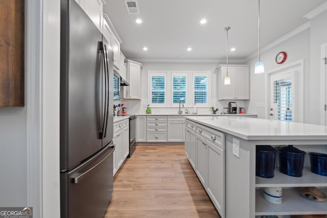 1290 Starboard Way, Greensboro, GA 30642 - kitchen featuring freestanding refrigerator, ornamental molding, light countertops, plenty of natural light, and light wood finished floors