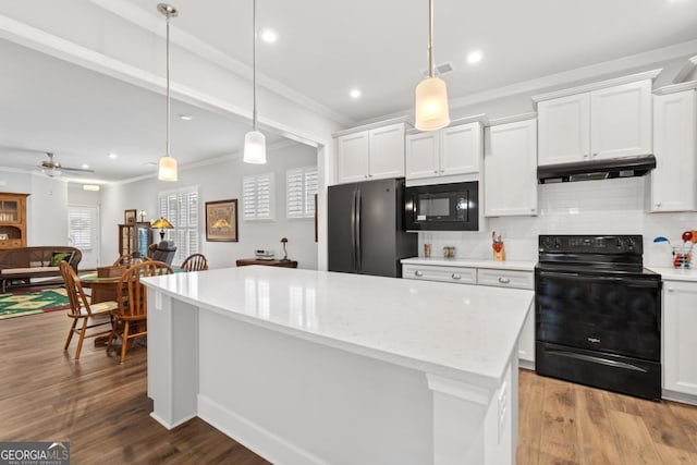 1290 Starboard Way, Greensboro, GA 30642 - kitchen with black appliances, under cabinet range hood, ornamental molding, backsplash, and white cabinetry