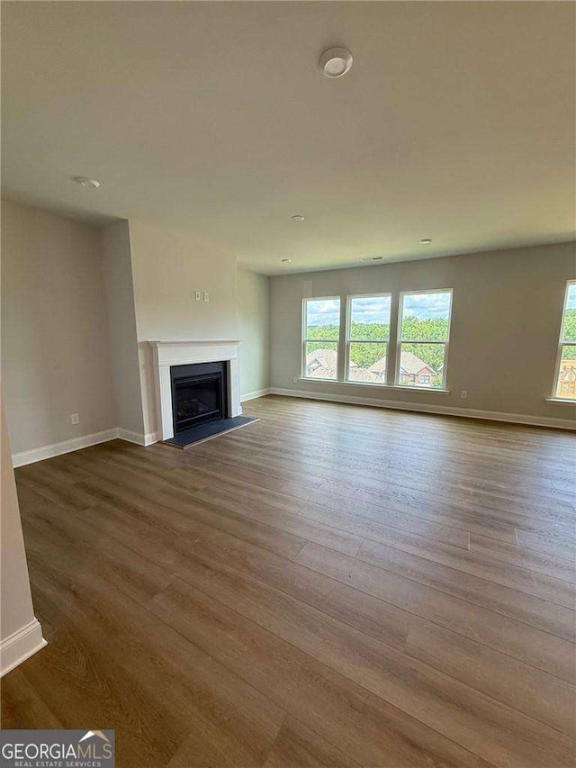4266 Azalea Ridge Way, Hoschton, GA 30548 - unfurnished living room with healthy amount of natural light, wood finished floors, and a fireplace