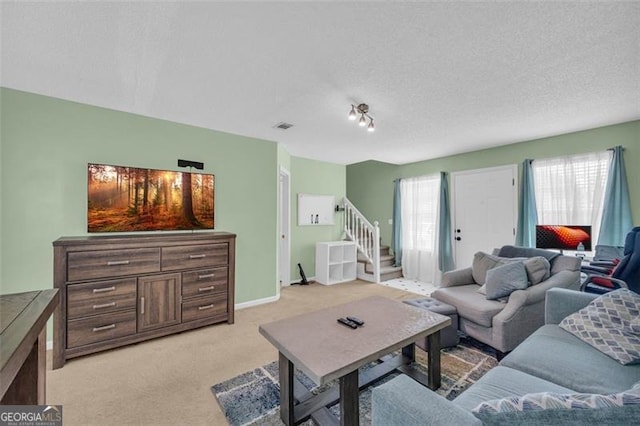 6178 Field Stone, Douglasville, GA 30134 - living area featuring light carpet, a textured ceiling, and stairway