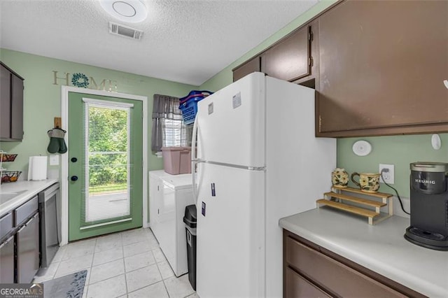 6178 Field Stone, Douglasville, GA 30134 - kitchen featuring freestanding refrigerator, separate washer and dryer, a textured ceiling, light countertops, and dishwasher