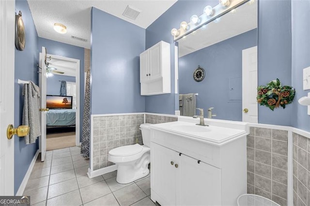 6178 Field Stone, Douglasville, GA 30134 - bathroom with tile walls, tile patterned flooring, vanity, wainscoting, and ensuite bath