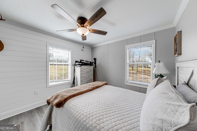 281 Jones Rd, Jefferson, GA 30549 - bedroom featuring wood finished floors, multiple windows, ornamental molding, and ceiling fan