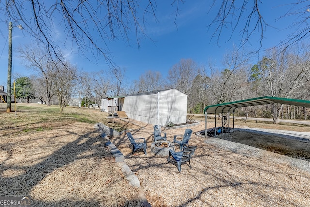 281 Jones Rd, Jefferson, GA 30549 - view of yard with a carport, an outdoor fire pit, and an outbuilding