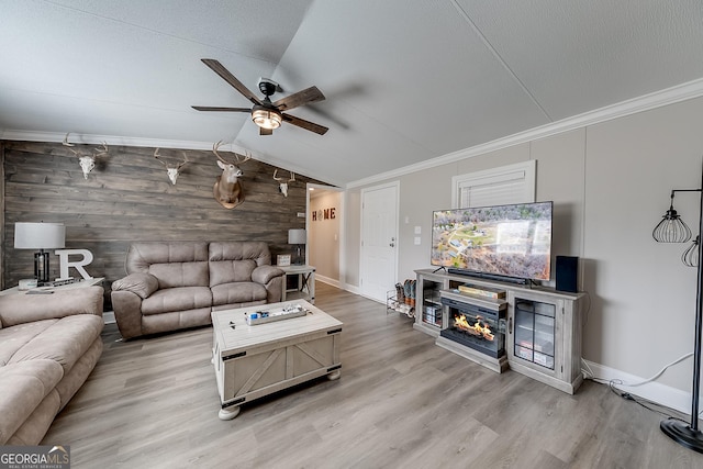 281 Jones Rd, Jefferson, GA 30549 - living room featuring vaulted ceiling, a ceiling fan, ornamental molding, wood finished floors, and wood walls