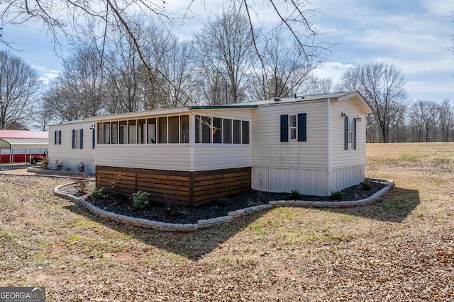 281 Jones Rd, Jefferson, GA 30549 - view of front of house with a sunroom and a detached carport