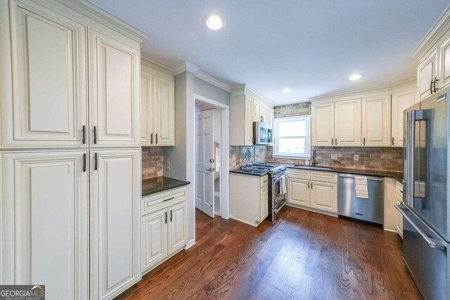 9805 Buice Rd, Alpharetta, GA 30022 - kitchen featuring high end appliances, dark countertops, decorative backsplash, dark wood-style floors, and recessed lighting