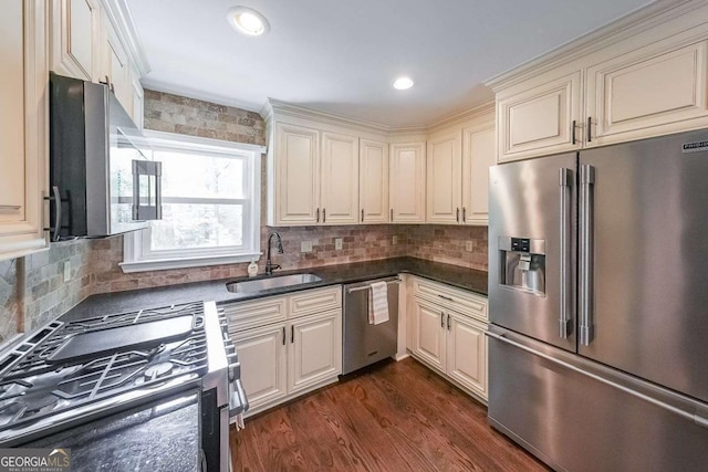 9805 Buice Rd, Alpharetta, GA 30022 - kitchen featuring stainless steel appliances, dark countertops, cream cabinets, decorative backsplash, and recessed lighting