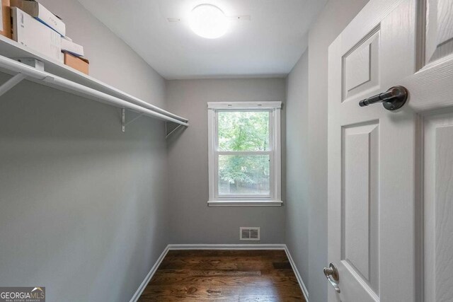 9805 Buice Rd, Alpharetta, GA 30022 - walk in closet featuring wood finished floors