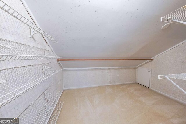 9805 Buice Rd, Alpharetta, GA 30022 - walk in closet with light carpet and lofted ceiling