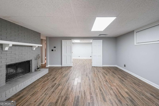 9805 Buice Rd, Alpharetta, GA 30022 - unfurnished living room featuring wood finished floors, a fireplace, and a paneled ceiling